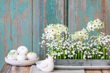 Florist at work: woman shows how to make Easter floral table decoration with arabian star flowers...