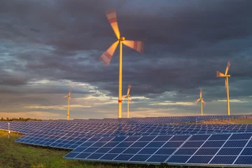 Fotobehang Natuur Park A solar farm near a wind farm against a dynamic sky  © Mike Mareen