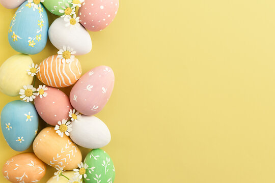 various multi-colored Easter eggs on a yellow background