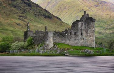 Kilchurn Castle with reflection in water at dramatic sunset, Nice Scotland landscape