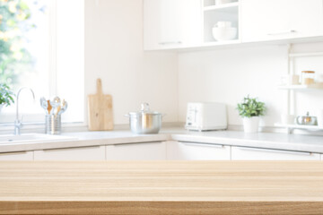 Wooden table top for product promotion over defocused modern kitchen counter background