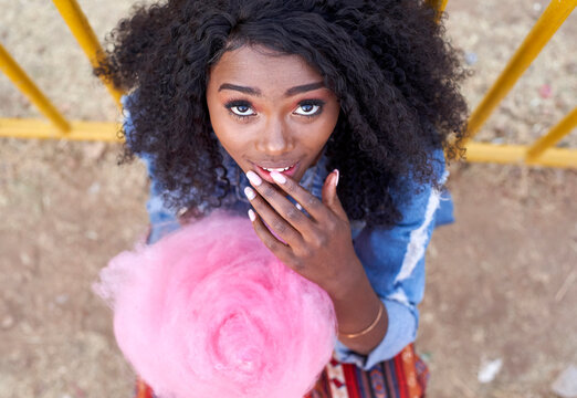 Portrait of young woman with pink candyfloss