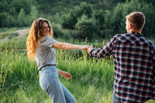 Romantic couple spending time in nature, holding hands
