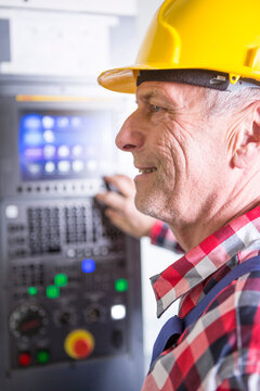 Worker operating high speed milling machine