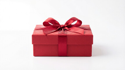 Obraz premium Red gift box with satin bow. Gift box isolated on white background, gift box for christmas greeting, valentines day message, birthday gift, anniversary promo, clean copy space, minimal studio style