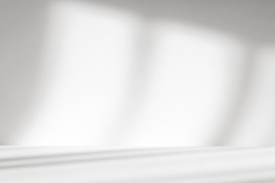 Abstract white studio background with shadows of window. Empty 3d gray room with copy space. Display product with blurred backdrop.