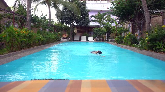 Asia, Vietnam , dive into the water and take a bath in the pool at a tourist accommodation in Asia - a swimming pool with clear water and lush greenery around the pool