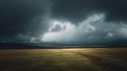 Fototapeta premium Stormy skies over a flat grassland, a single beam of light breaking through clouds onto the field. Concept Stormy Sky Over Flat Grassland, Single Beam of Light Through Clouds