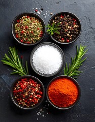 Culinary Spices: Aromatic Herbs, Salt, and Peppers in Black Bowls on Dark Slate