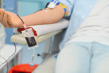 Blood donor giving blood during donation process