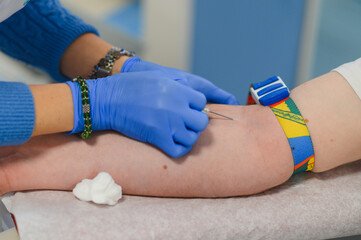 Medical professional drawing blood from donor arm