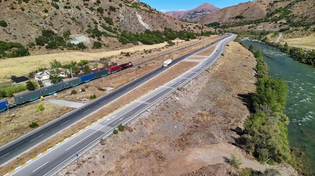 International Highway with Heavy Truck Traffic and Mountain Landscape