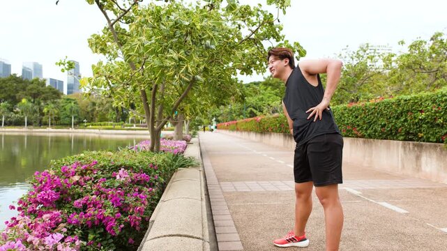 Asian Man Stretching and Warming Up in Benjakitti Park Bangkok