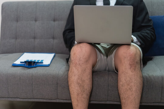 Business person working from home wearing suit and shorts