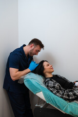 Trichologist performs scalp mesotherapy with microinjections.