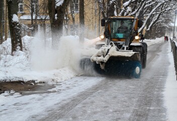 Transport with a big brush is cleaning street town sidewalk pavement removing snow winter snowy day urban photo  © Elena K
