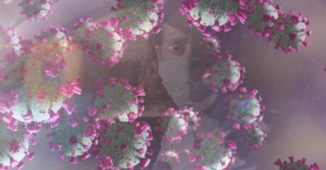 Composition of covid 19 cells floating over man in face mask