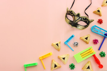 Purim celebration concept (jewish carnival holiday) over pink background