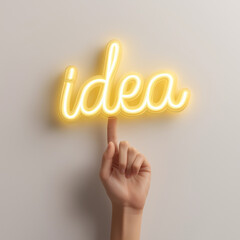 a hand touching to the word "idea" in yellow neon light