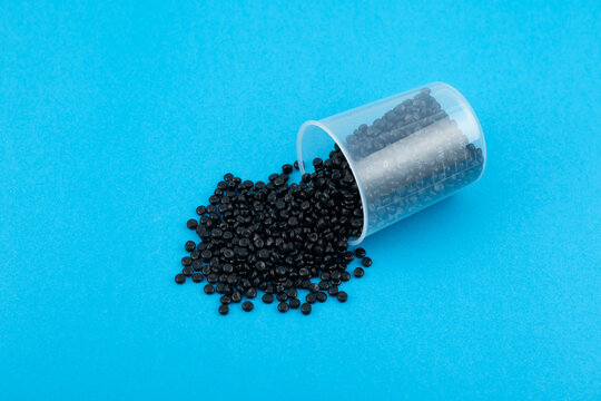 Black polyethylene granules or masterbatch. Plastic recycling. Granulated plastic polymer colored with carbon black pigment