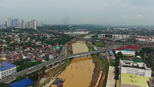Aerial shot of Marikina River Metro Manila shows bridge construction, buildings