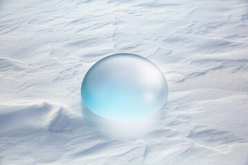 A close-up shot of a clear water droplet resting on the snow