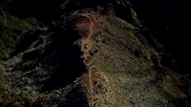 4K High Contrast Aerial Flyover of Pico Ruivo, Madeira: Fast Tracking Shot Over Volcanic Ridge, Dramatic Shadows and Burned Trees Aftermath, Dark Peak Texture, Cinematic Top-Down Mountain Surface