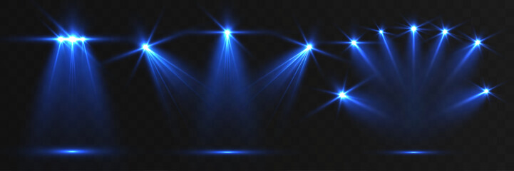 Blue stage spotlights with glowing beams and lens flares on dark opaque background, concert lighting abstract effect.