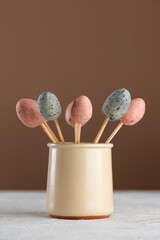 Sweet marzipan Easter eggs on a stick. Vegan candy. Sugar, gluten and lactose free.