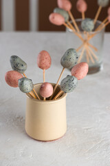 Homemade sweet marzipan Easter eggs on a sticks. Vegan candy. Sugar, gluten and lactose free. Vertical orientation.