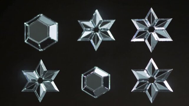 Moving spotlights sweeping across 3x2 grid of six crystal ornaments in dark studio, revealing cuts