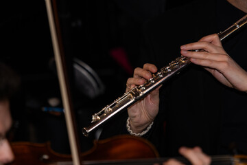 Professional Musician Playing Silver Flute During Classical Concert © Ruslan