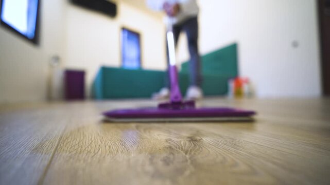 First-person domestic scene showing woman doing housework, mopping the floor, and maintaining a clean home