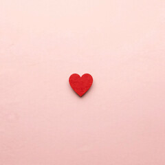 Fototapeta premium Red heart shape cast on a bright lit surface