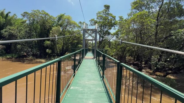 POV: Walking across metal bridge over Crocodile River in South Africa