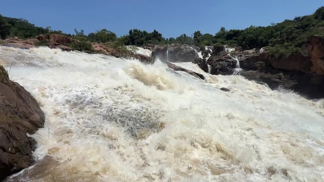 Flooding Crocodile River rushes down Cascade falls in South Africa