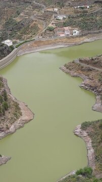 Exploring the Los Perez dam from the air on the island of Gran Canaria, Canary Islands.