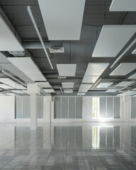 Empty modern open space interior with acoustic ceiling panels and tile floor