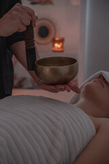 Sound therapy moment with bowl suspended above client