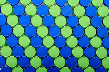 Large group of plastic bottles lined up on a table.