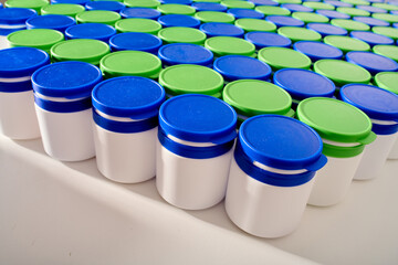 Large group of plastic bottles lined up on a table.