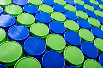 Large group of plastic bottles lined up on a table.