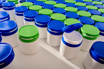 Large group of plastic bottles lined up on a table.