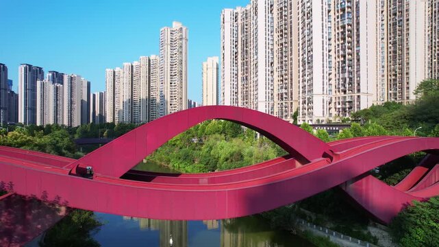 Red Bridge Over Water with Modern City Skyline, Changsha Meixi Lake