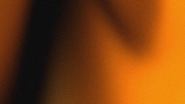 Glowing abstract grainy orange and black gradient background with vintage film noise texture