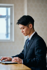 Businessman Typing on Laptop at Office Desk