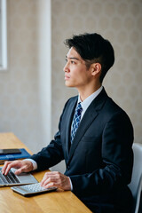 Businessman Typing on Laptop at Office Desk