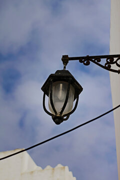 Traditional street lamp against blue sky - Vintage Street Lantern Against Clear Blue Sky in Asilah, Morocco