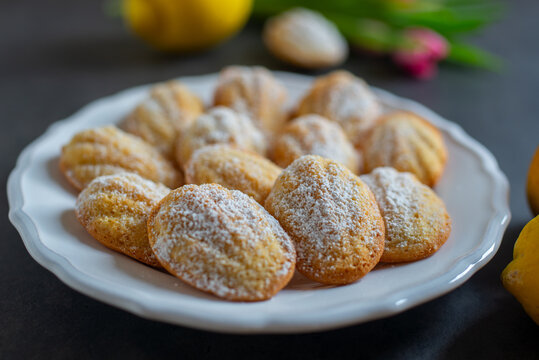 Freshly baked french madeleines with lemon