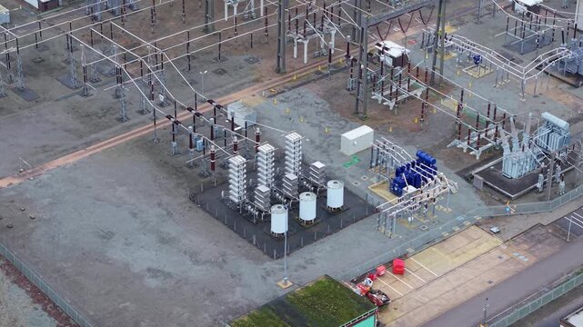 Technical aerial shot of substation busbar arrangements and high-capacity connectors at Enderby, highlighting grid resilience and power flow.
